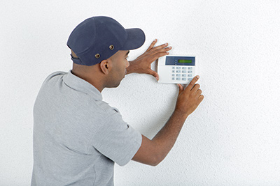 Monmouth County air conditioner repair professional checking a thermostat